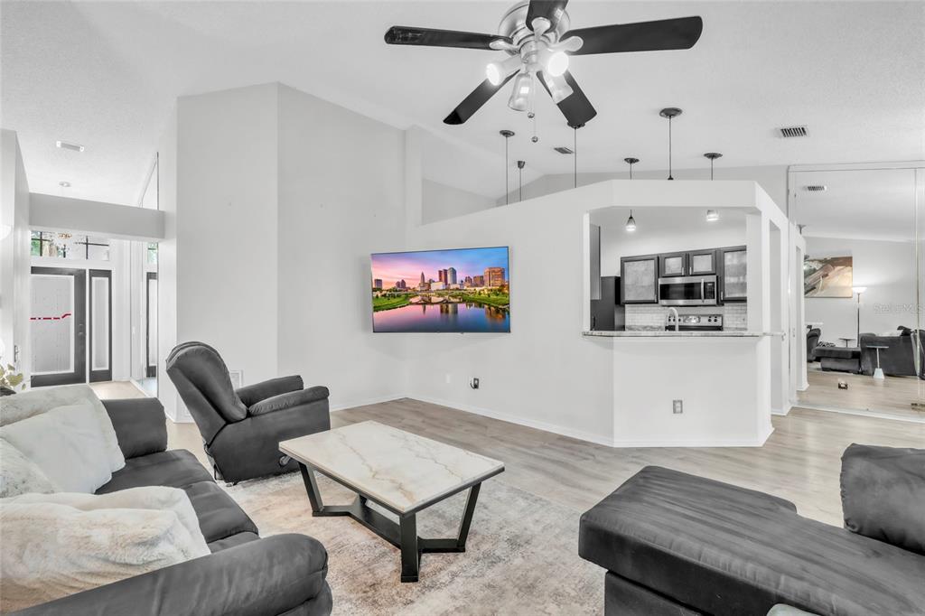 12410 Early Run Lane Riverview, FL 33578 - Photo 6 of 34 a living room with furniture kitchen view and a wooden floor