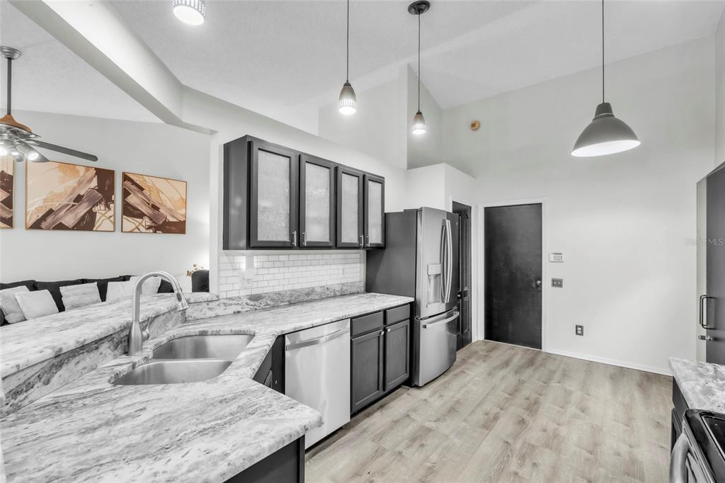 12410 Early Run Lane Riverview, FL 33578 - Photo 9 of 34 a kitchen with stainless steel appliances granite countertop a sink refrigerator and cabinets