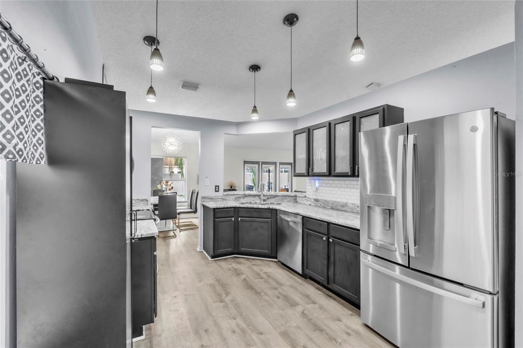 12410 Early Run Lane Riverview, FL 33578 - Photo 10 of 34 a large kitchen with cabinets and stainless steel appliances