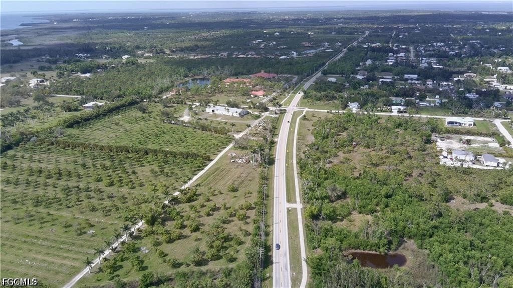 11900 Stringfellow Road Bokeelia, FL 33922 - Photo 2 of 8 an aerial view of residential houses with outdoor space and trees