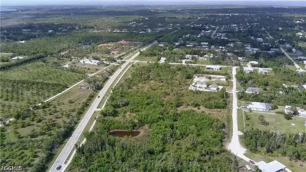 an aerial view of residential houses with outdoor space and lake view