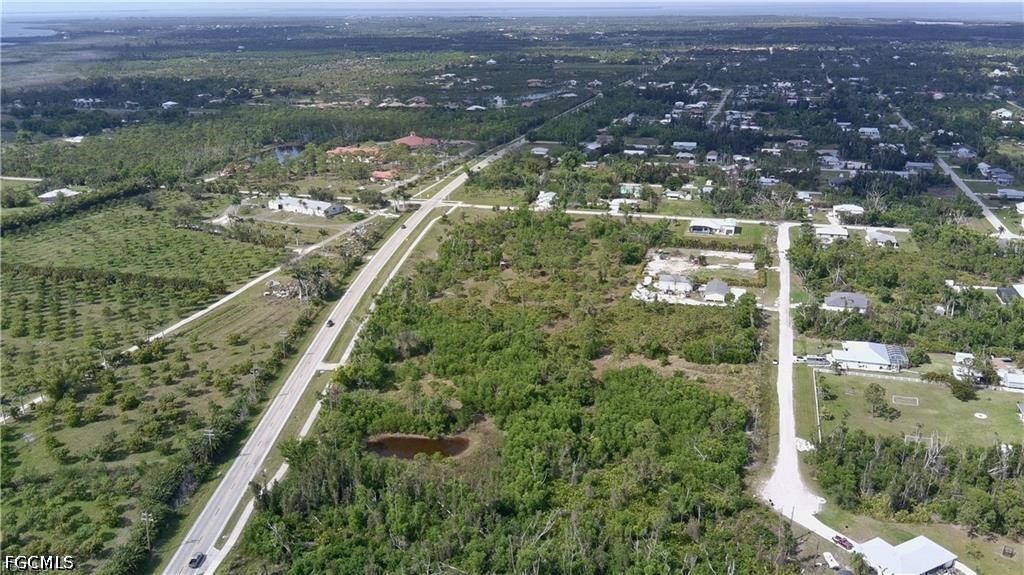 11900 Stringfellow Road Bokeelia, FL 33922 - Photo 3 of 8 an aerial view of residential houses with outdoor space and lake view