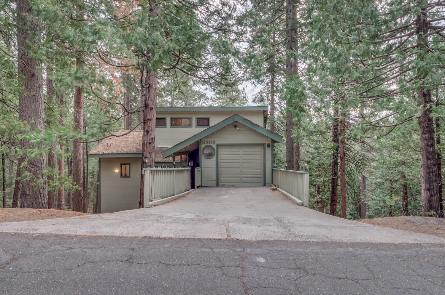 3303 Apache Road Dorrington, CA 95223 - Photo 1 of 1 a front view of a house with a yard and garage