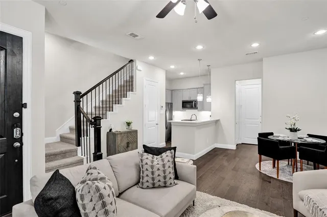 a living room with furniture and kitchen view