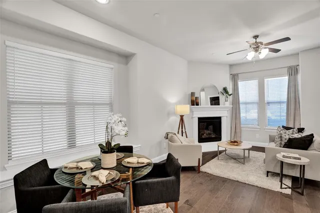 a living room with furniture fireplace and a large window
