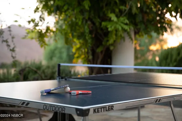 a view of a swimming pool with lounge chairs in patio