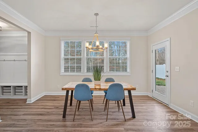 a view of a dining room with furniture wooden floor and windows
