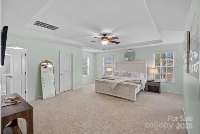 a spacious bedroom with a bed dresser and a window