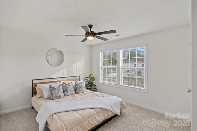 a bedroom with a large bed and a window