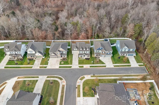 an aerial view of residential house with outdoor space and swimming pool
