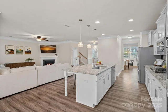 a large white kitchen with stainless steel appliances