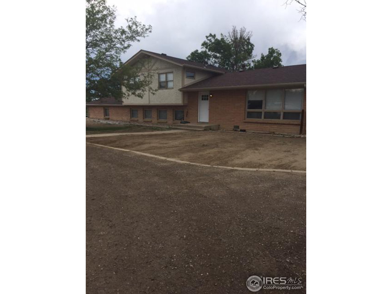 a view of a room that has a window and a table in it