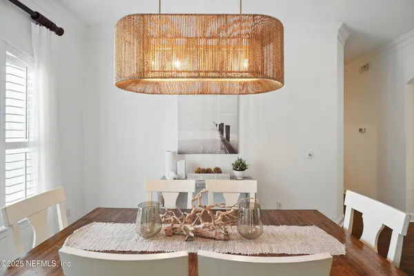 a view of a dining room with furniture wooden floor and chandelier