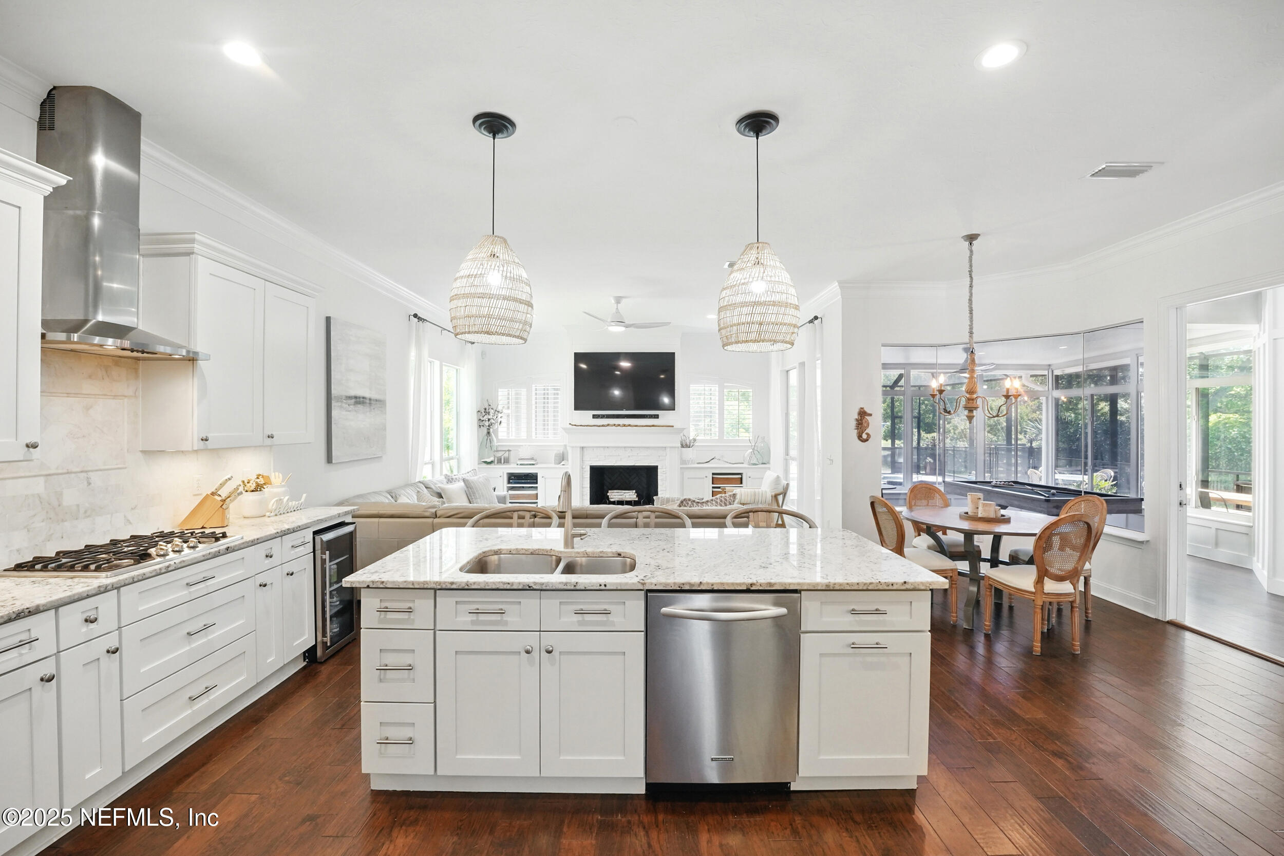 150 South Roscoe Boulevard Ponte Vedra Beach, FL 32082 - Photo 24 of 84 a open kitchen with stainless steel appliances granite countertop a sink a microwave a dining table and chairs with wooden floor