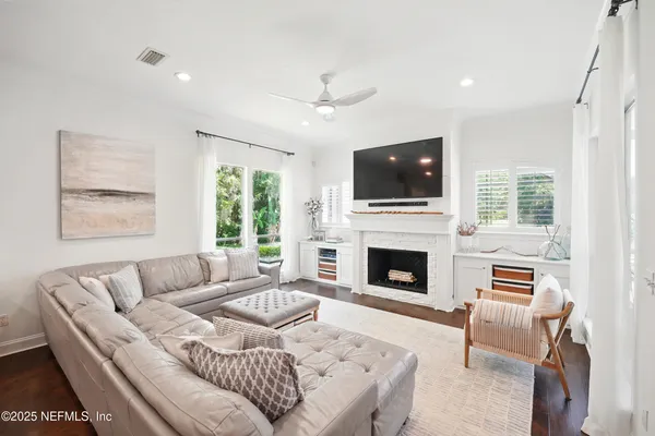a living room with furniture and a wooden floor