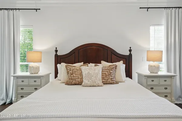 a bedroom with a bed and a chair