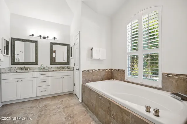 a bathroom with sink and mirror