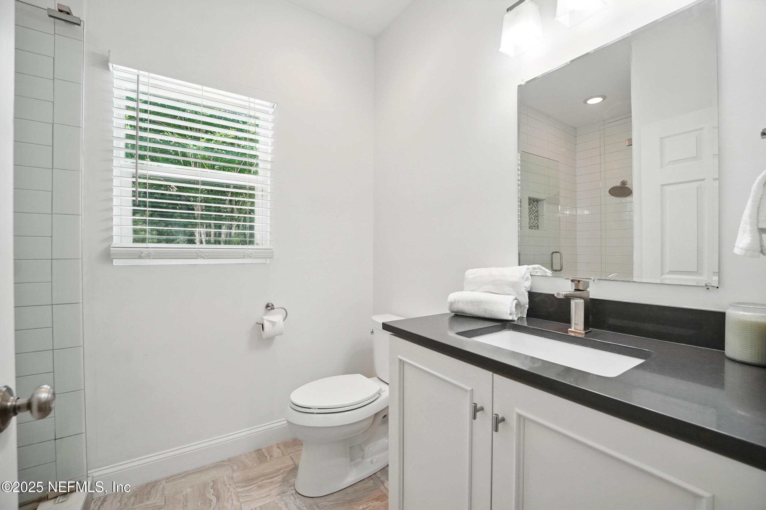 150 South Roscoe Boulevard Ponte Vedra Beach, FL 32082 - Photo 37 of 84 a bathroom with a granite countertop sink a toilet and a mirror