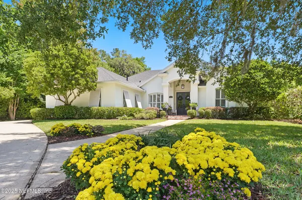 a front view of a house with a flower garden