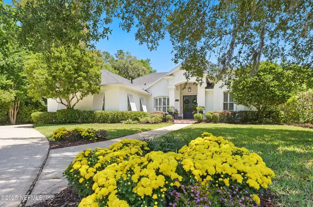 a front view of a house with a flower garden