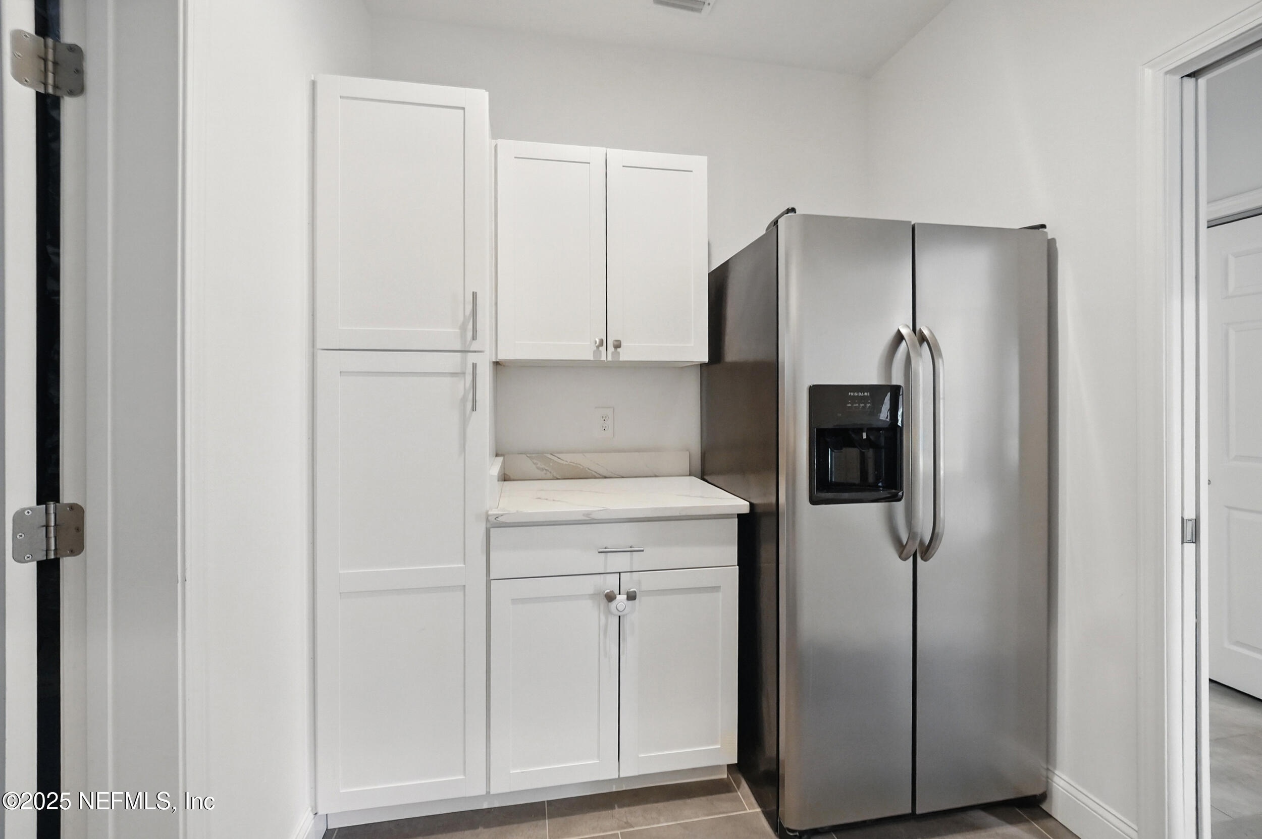 150 South Roscoe Boulevard Ponte Vedra Beach, FL 32082 - Photo 53 of 84 a kitchen with a refrigerator and cabinets