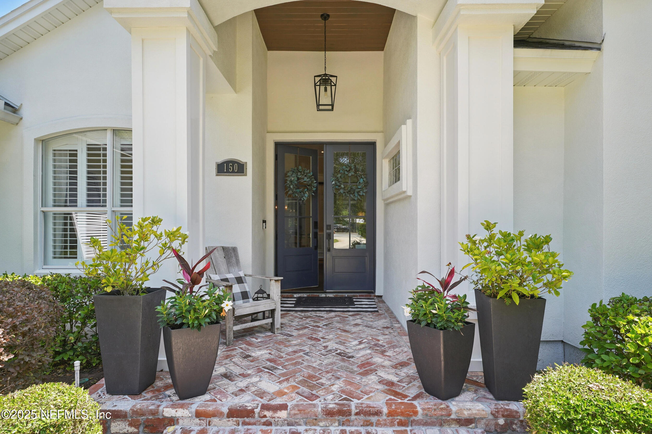 150 South Roscoe Boulevard Ponte Vedra Beach, FL 32082 - Photo 6 of 84 a front view of a house with a flower garden