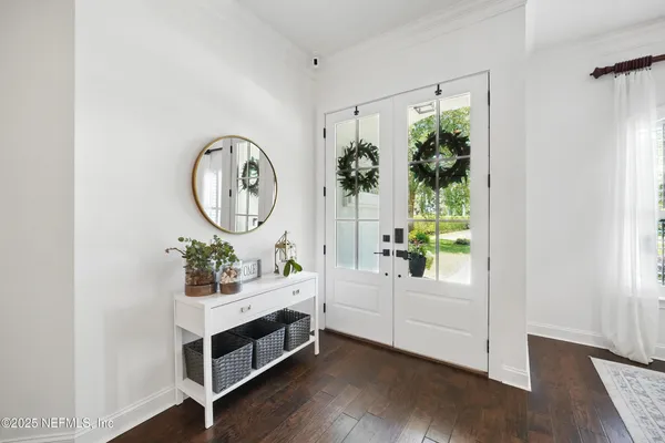 a bathroom with a sink a mirror and a potted plant