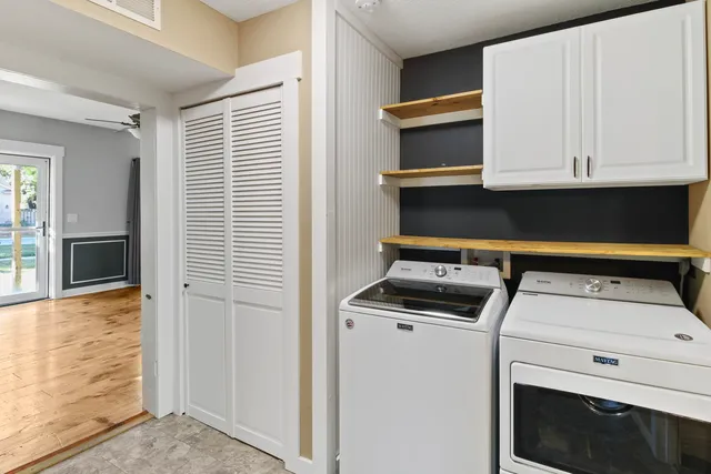 a view of washer and dryer with kitchen in the background