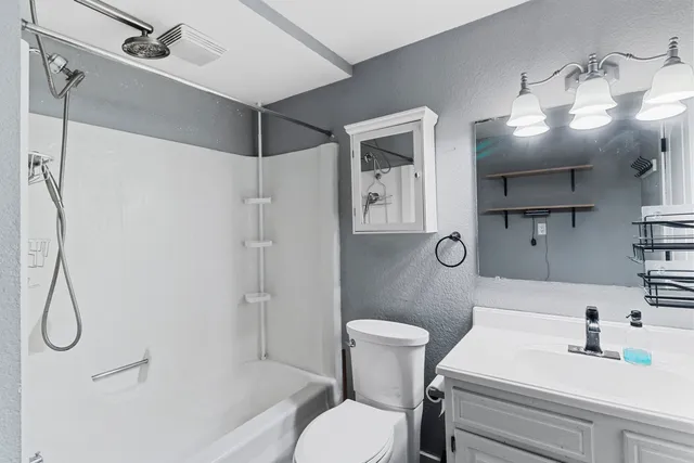 a bathroom with a sink toilet and shower