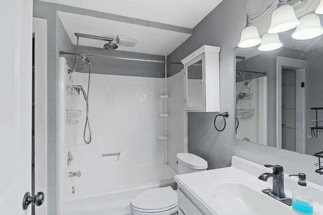 a bathroom with a sink toilet and shower