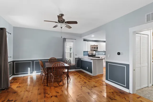 a view of a dining room with furniture and a chandelier