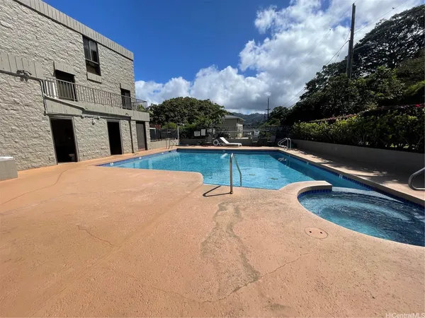 a view of a swimming pool with a yard