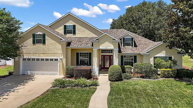 a front view of a house with a yard and garage