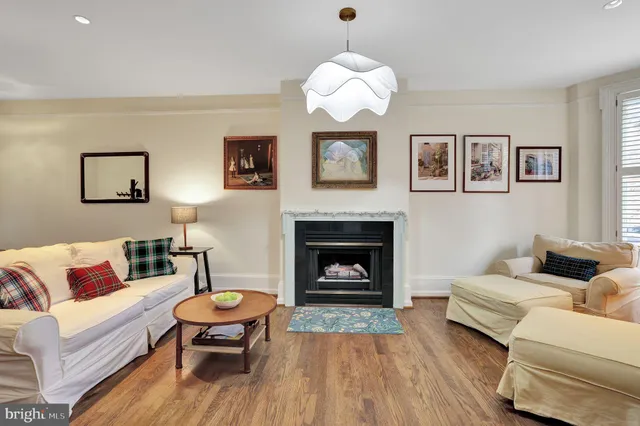 a living room with furniture and a fireplace