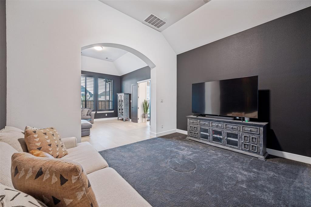 4400 Meander Way Prosper, TX 75078 - Photo 17 of 40 a living room with furniture and a flat screen tv