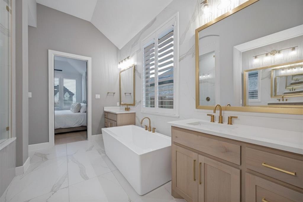 4400 Meander Way Prosper, TX 75078 - Photo 19 of 40 a en suite bathroom with a double vanity sink a mirror and a shower