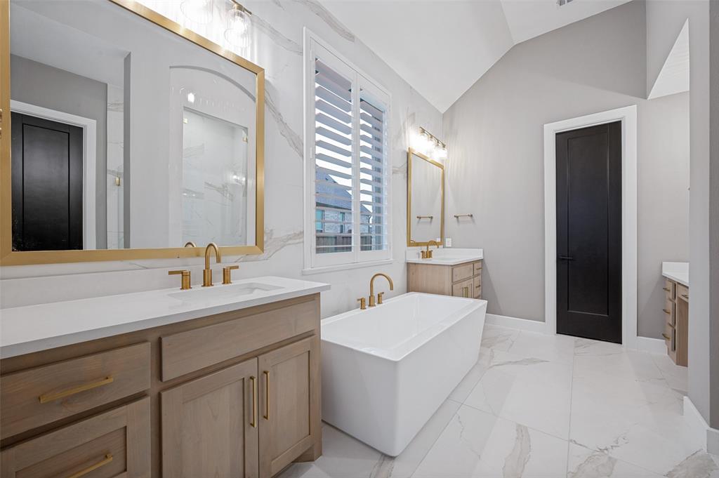 4400 Meander Way Prosper, TX 75078 - Photo 20 of 40 a bathroom with a sink and a mirror