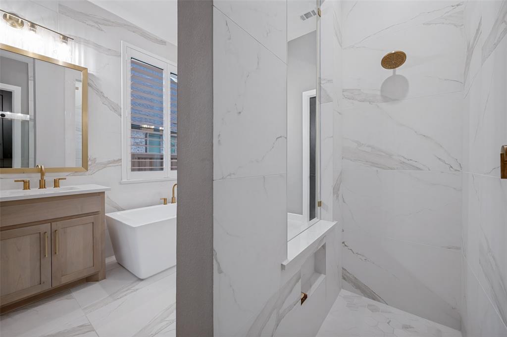 4400 Meander Way Prosper, TX 75078 - Photo 21 of 40 a bathroom with a sink a toilet and shower