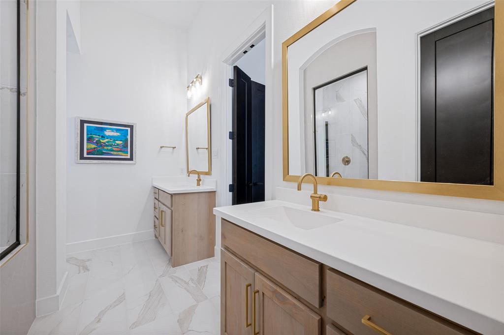 4400 Meander Way Prosper, TX 75078 - Photo 23 of 40 a bathroom with a sink and a mirror