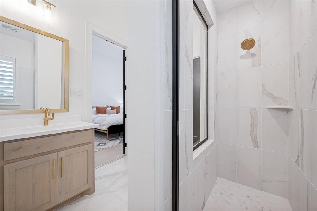 4400 Meander Way Prosper, TX 75078 - Photo 24 of 40 a en suite bathroom with a granite countertop sink and a mirror