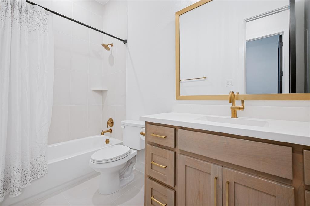 4400 Meander Way Prosper, TX 75078 - Photo 25 of 40 a bathroom with a sink a toilet and shower