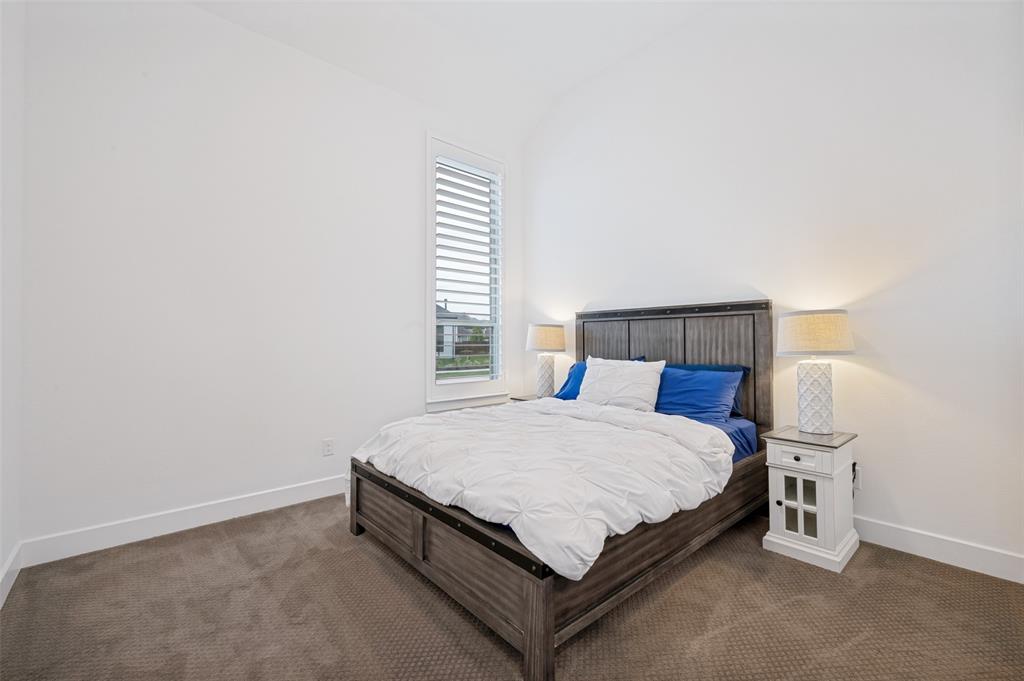 4400 Meander Way Prosper, TX 75078 - Photo 26 of 40 a bed sitting in a bedroom next to a window