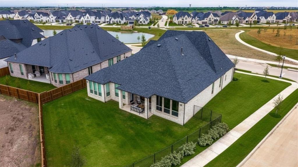 4400 Meander Way Prosper, TX 75078 - Photo 32 of 40 an aerial view of a house with a swimming pool a yard and lake view