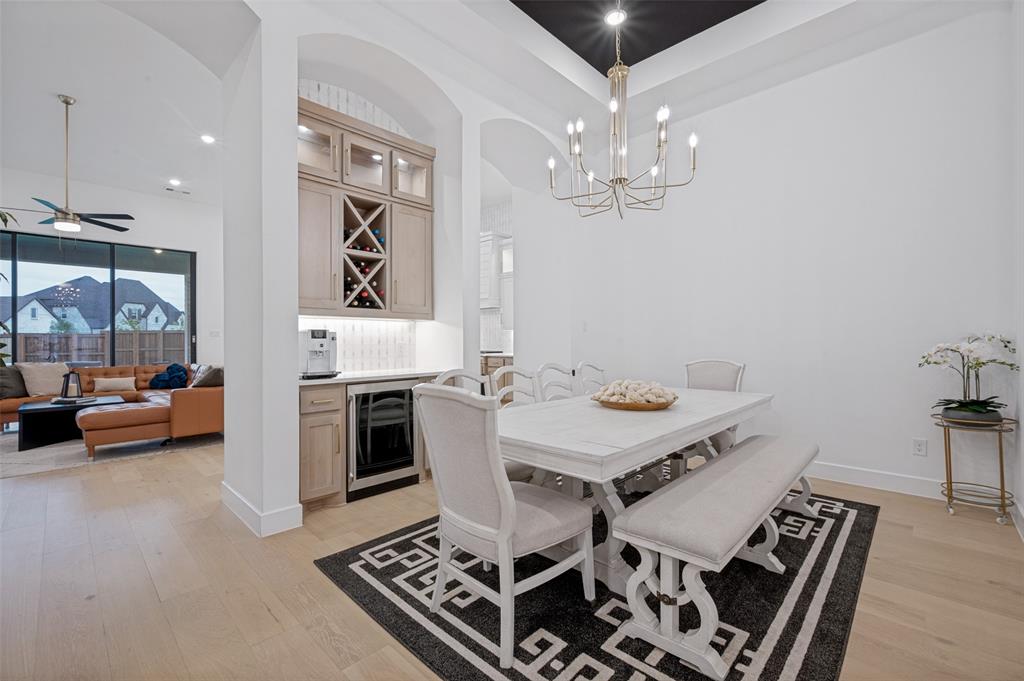 4400 Meander Way Prosper, TX 75078 - Photo 5 of 40 a view of a dining room with furniture and wooden floor