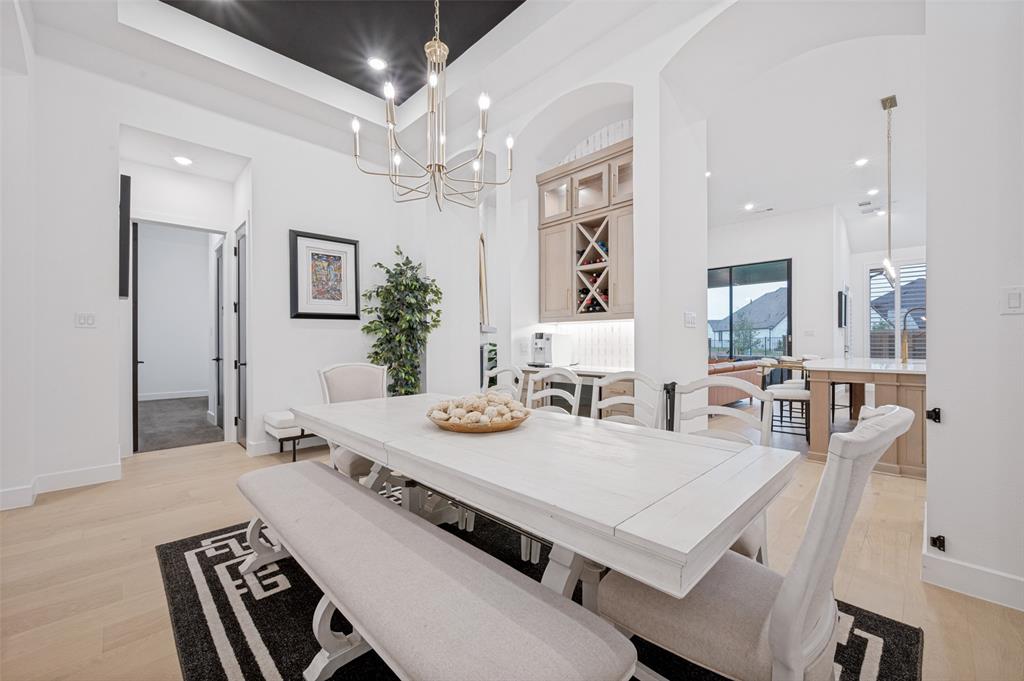 4400 Meander Way Prosper, TX 75078 - Photo 6 of 40 a view of a dining room with furniture and chandelier