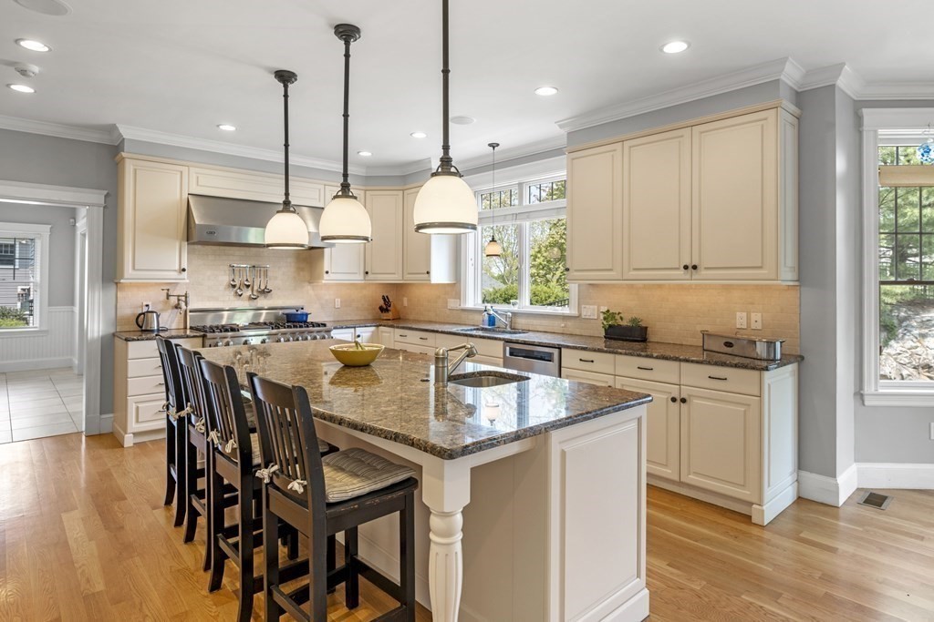 6 Captains Walk Lane Marblehead, MA 01945 - Photo 17 of 39 a kitchen with stainless steel appliances granite countertop wooden floor sink stove and white cabinets next to a window
