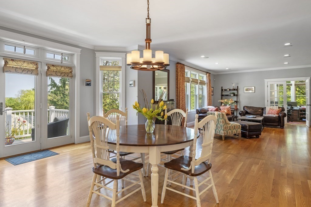 6 Captains Walk Lane Marblehead, MA 01945 - Photo 18 of 39 a dining room with wooden floor a chandelier a glass table and chairs