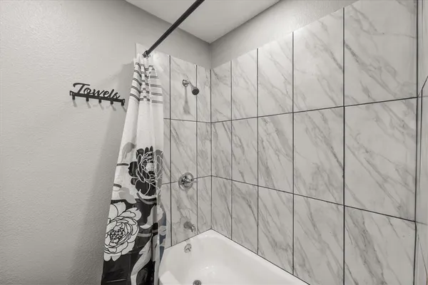 a bathroom with a bathtub and shower