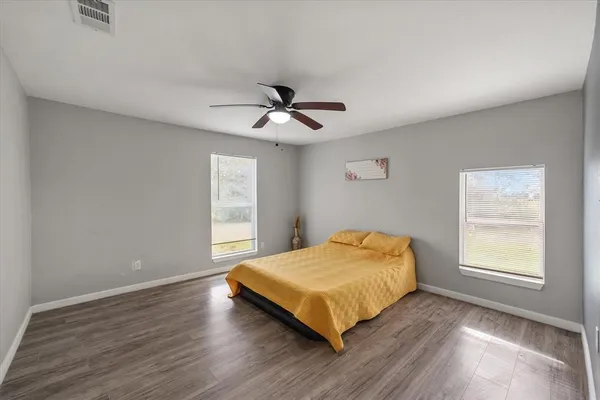 a bedroom with a bed and window