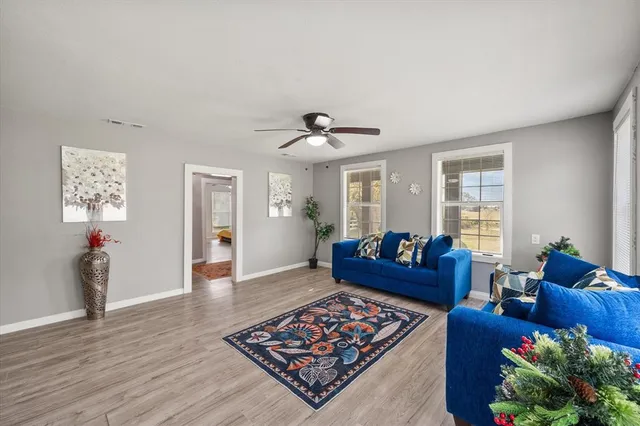 a living room with furniture and wooden floor